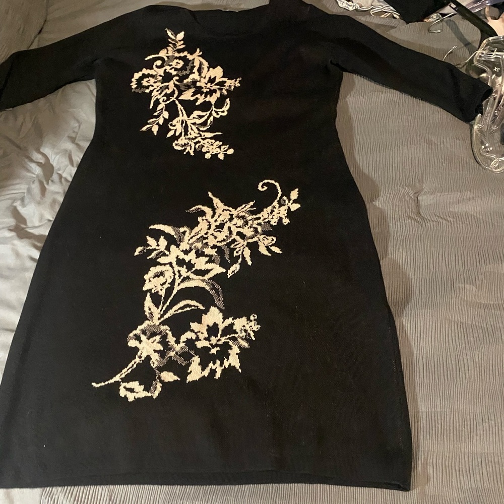Black sweater dress with a floral detail